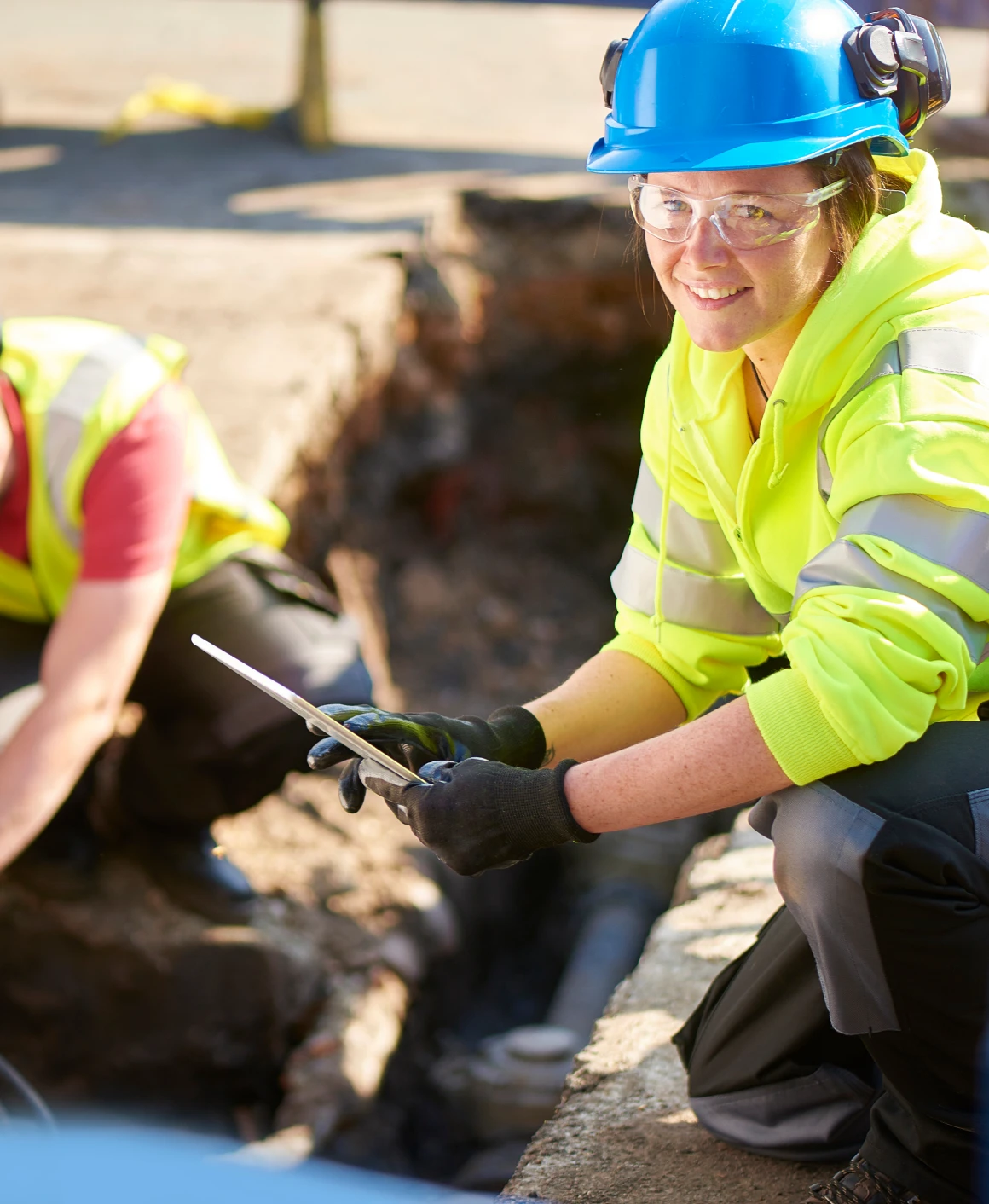 Person inspecting construction site with tablet
