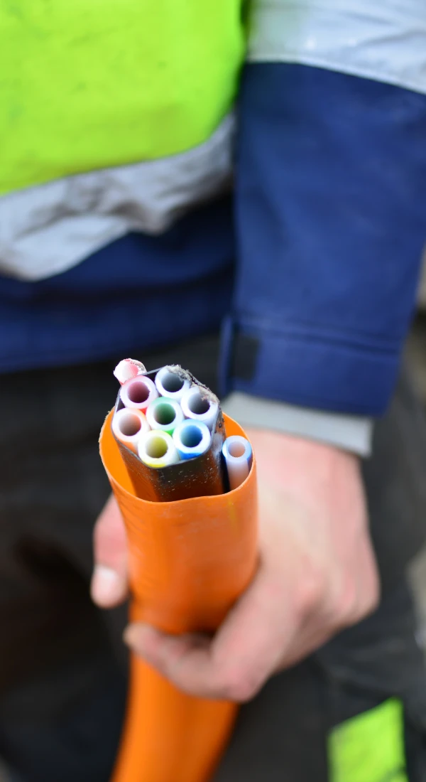 Worker holding colorful fiber optic cables